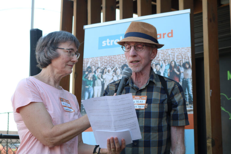 A man and woman giving a speech on stroke awareness