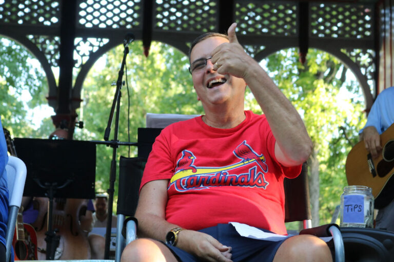 A man in a wheelchair giving a thumbs up